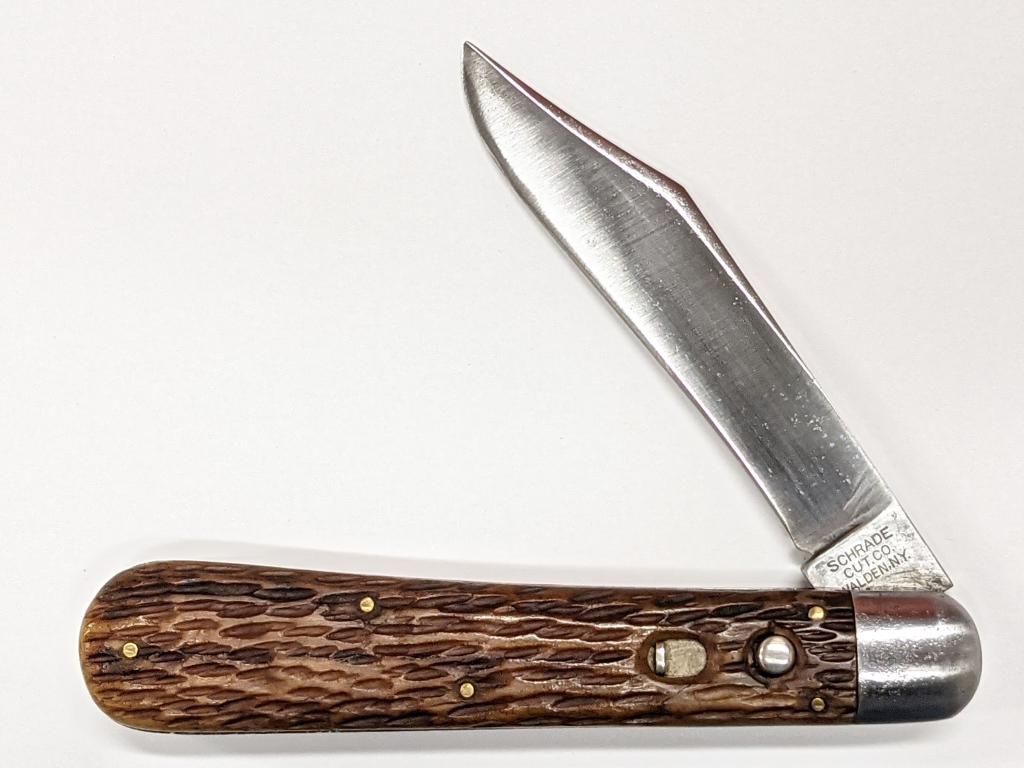 Early Schrade Bone Handle Switchblade Knife: 4-7/8" closed. Tang has early Schrade Cut. Co. stamps. Handle is a jigged bone with a toffee/carmel color. Blades shows signs of use and sharpening, knife is in very good overall condition.