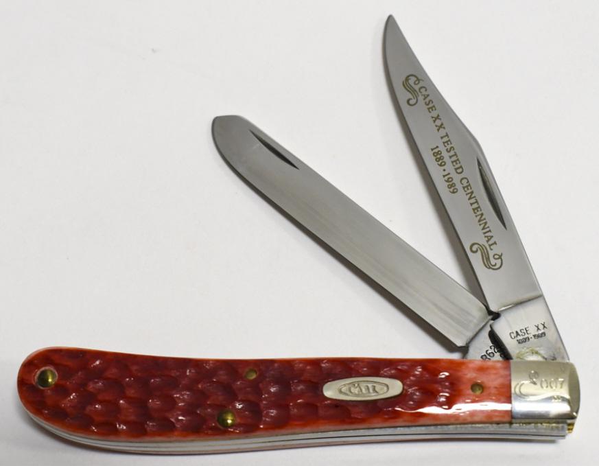 1989 Case XX Centennial 007/500 Slimline Trapper: 1989 Case XX limited Centennial edition model no. R62048 Slimline Trapper two blade red jig bone folding knife. Knife appears to be in nice condition with wear from display, storage, and age. When clo