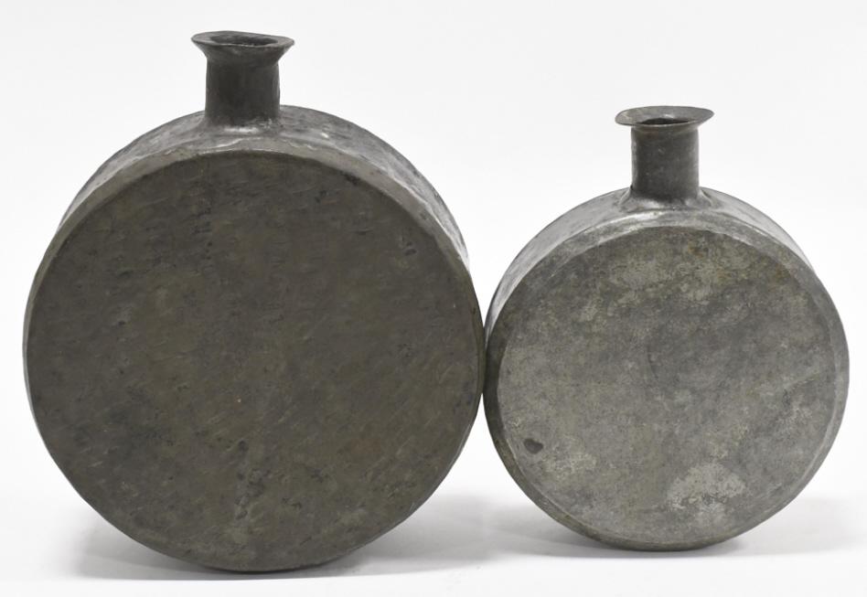 2 Civil War Confederate Non Regulation Canteens: Lot of two Civil War Confederate style non regulation metal drum canteens. Both canteens have dents and wear. They display well. The largest measures approximately 6-1/2" tall by 5-1/2' across by 2-1/
