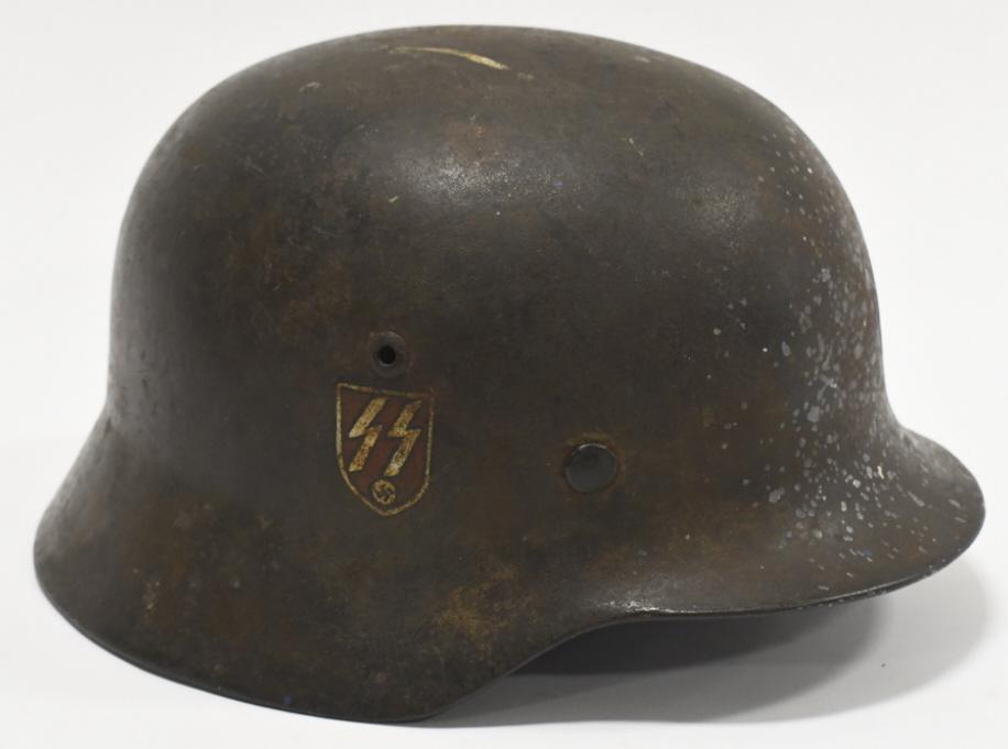 WWII German M35 MIlitary Heer Combat Helmet: WWII German military M35 Heer combat helmet with hand painted "SS" insignia. Helmet features a toned heer winged egal decal and a unique hand painted SS insignia. Shell has paint loss, decal loss, and