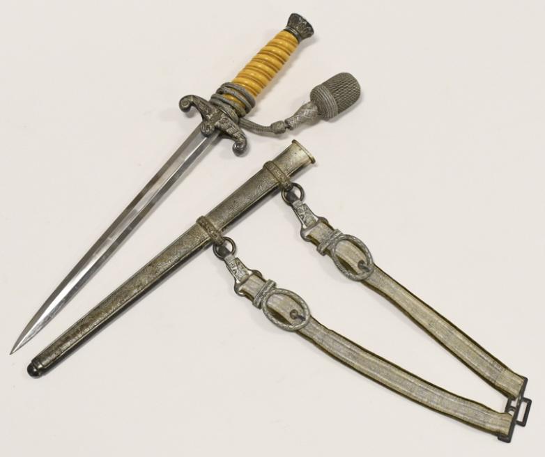 WWII German Army Officer's Dagger With Scabbard: WWII German Army Heer Officer's dagger with scabbard, portepee knot, and hanger. Appears to be in good condition with toning, plate loss, and wear from use and age. Blade is unmarked. Overall with sca