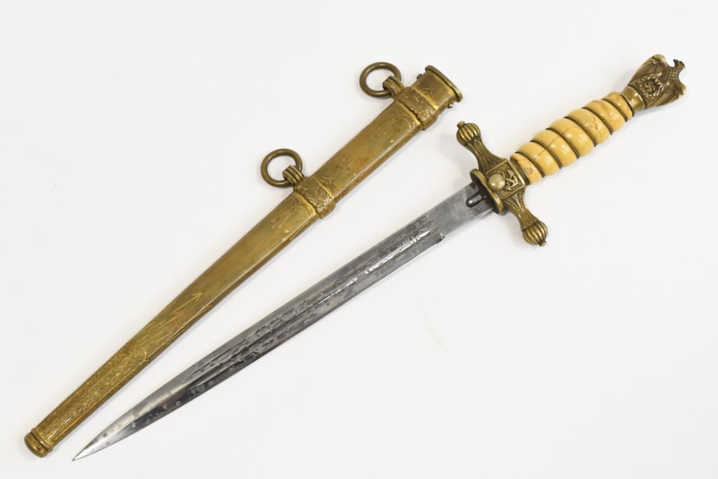 WWII German Kriegsmarine Dagger With Scabbard: WWII German Kriegsmarine dagger with scabbard. Appears to be in fair condition with toning, surface rust on bottom of blade, damge to handle grip, and wear from use and age. Blade is marked " E.F. Hor