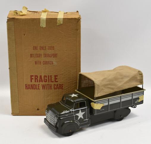 Marx #1899 Military Transport Truck w/ Box: Marx #1899 military transport truck with the original box. The truck is supposed to come with a cannon that it is missing. The truck has old masking tape on all 4 corners of the bed of the truck. The