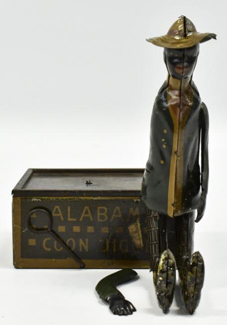 Ferdinand Strauss Tombo The Alabama Coon Jigger: Tin litho windup Ferdinand Strauss Corporation Tombo "The Alabama Coon Jigger". The windup mechanism works. It is missing the pole, one of the arms is a reproduction, and the tab on the other arm is b