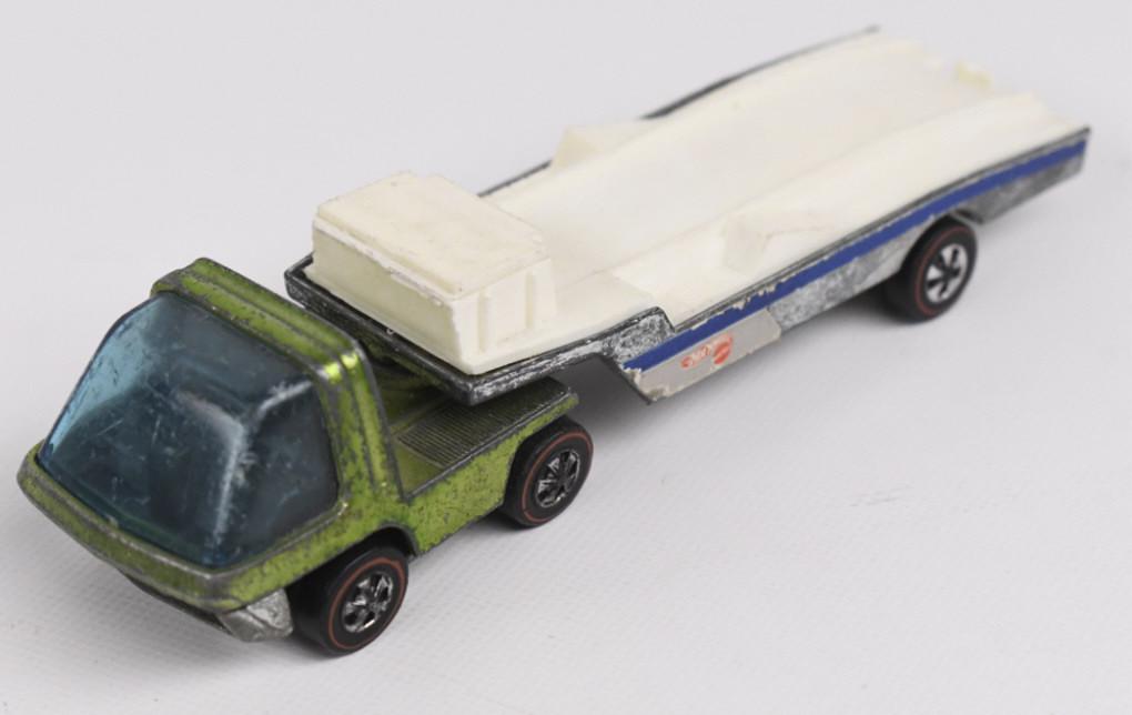 Hot Wheels Redlines Racing Trailer: Hot Wheels Redline Heavyweights Racing Rig with Light green cab. Appears to be in overall good condition with wear to cab and glass. The trailer is nice with ramp intact. Cab wheels have wear and trai