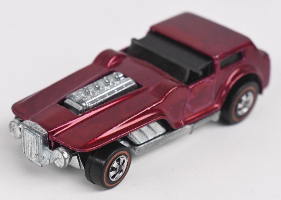 Hot Wheels Redline Rose The Hood: Hot Wheels Redline Rose The Hood. Appears to be near mint with a bit of light toning on the roof and light wear from age and display. Has fantastic wheels and base.