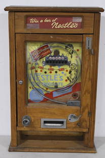 Vintage Nestle's Chocolate Penny Drop Arcade Game: Unique vintage wall mount Nestle's Chocolate penny drop arcade game / chocolate bar vendor by R&W london. Appears to be in overall good cosmetic condition with wear to wood case, cracking / discolorat