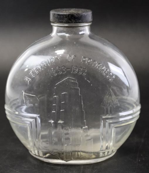 1933 Century Of Progress Chicago Water Bottle: 1933 Century of Progress Chicago glass water bottle with lid. Features the GE Building, log cabin, and teepee. It measure 6.5" tall x 5.5" across and are in nice condition.