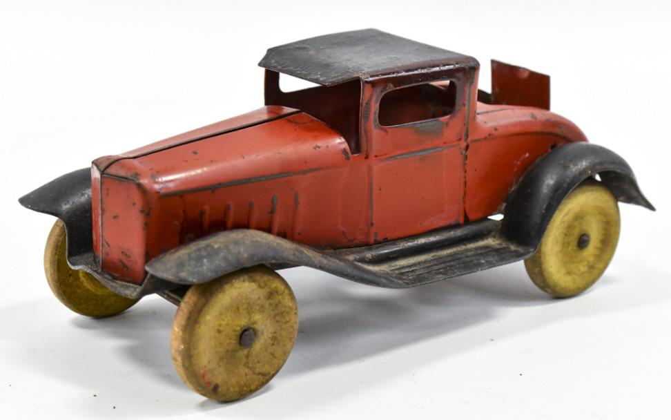 Wyandotte Coupe with Rumble Seat: Wyandotte coupe with rumble seat. The car has yellow wooden wheels. The car has some areas of older overpaint. Measures approximately 8" long.