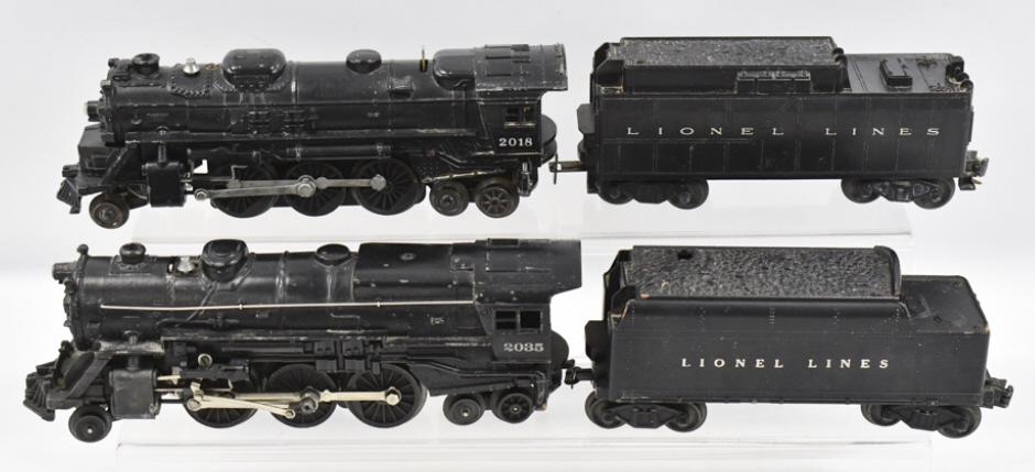 Lionel #2035 & #2018 Engines With Tenders: Lionel 2-6-4 #2035 engine with #6466W tender and 2-6-4 #2018 engine with tender. The engines and tenders have paint chips and wear from use and age.