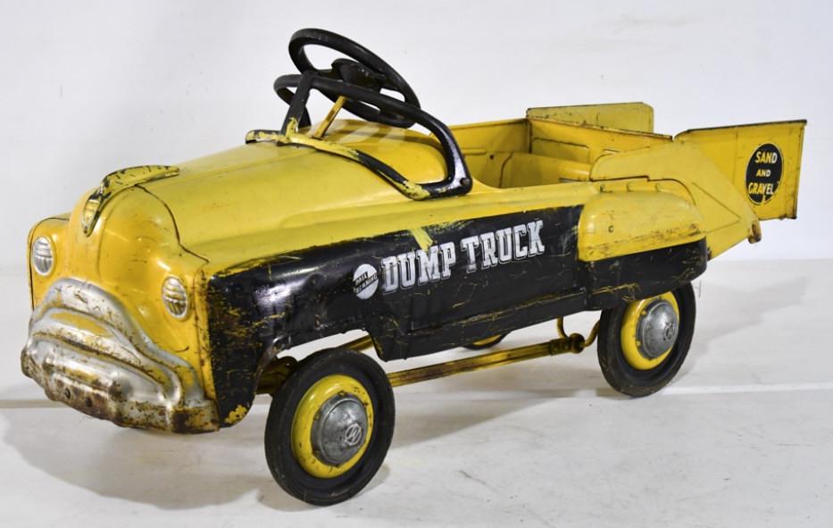 Murray Sand & Gravel Dump Truck Pedal Car: Murray sand and gravel dump truck pedal car. The truck is original with some overpaint. The bed dumps. The truck has paint loss and wear from use and age. Measures approximately 45" long
