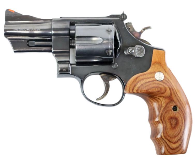 Smith & Wesson Model 24-3 .44 Special Revolver: Smith & Wesson Model 24-3 six-shot revolver in .44 S&W Special. The blue finish revolver is in like new condition in a S&W hard plastic case, has a 3" barrel and Combat wood grips. SN: AEM7569. Requir