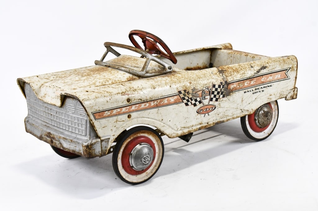 Original Murray Speedway 500 Pace Car Pedal Car: Original Murray Speedway 500 pace car pedal car. Displays well with racer and checkered flag graphics. The car has paint loss, surface rust, and wear from age. Measures approximately 35" long.