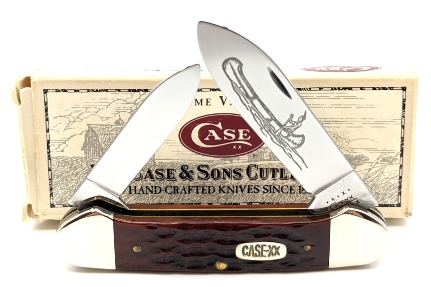 2000 Case XX Jigged Red Bone Canoe 62131: 2000 Case XX Jigged Red Bone Canoe 62131 w/ Box. Knife is in like new condition with Native American in a canoe etched onto main blade. Largest blade length of 2-7/8in and overall length of 8in when o