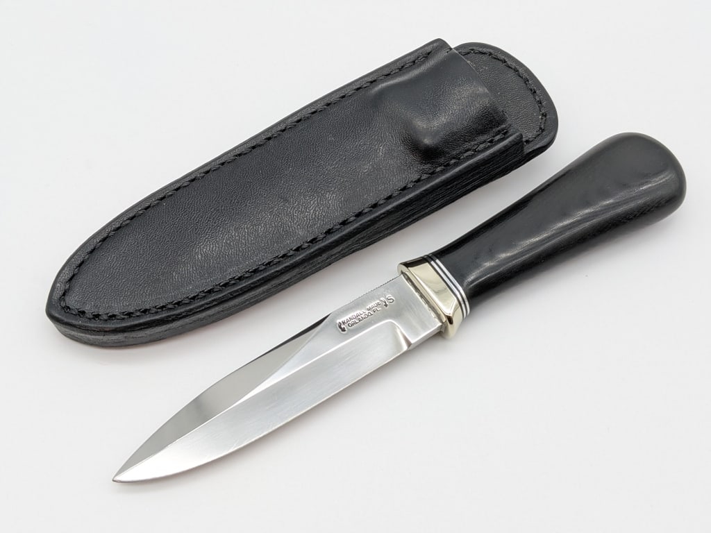 Randall Made 4in Gambler w/ Randall Sheath: Randall Made 4in Gambler w/ Randall Sheath. Knife features stainless steel blade, reduced style nickel hilt and black micarta handle. Knife is in nice condition with some scratches on the blade. Blade