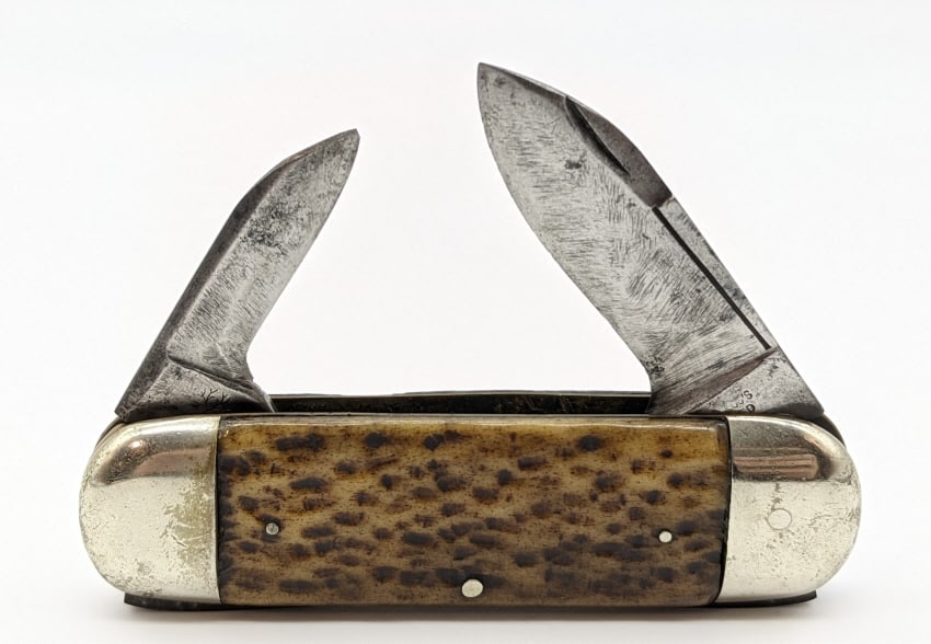 H. Boker Sunfish Elephants Toe Style Knife: H. Boker Jigged Bone Sunfish Elephants Toe Style Knife. Knife is in worn condition with original blades with heavy material loss and scratches. Largest blade length of 2-1/2in and overall length of 7-