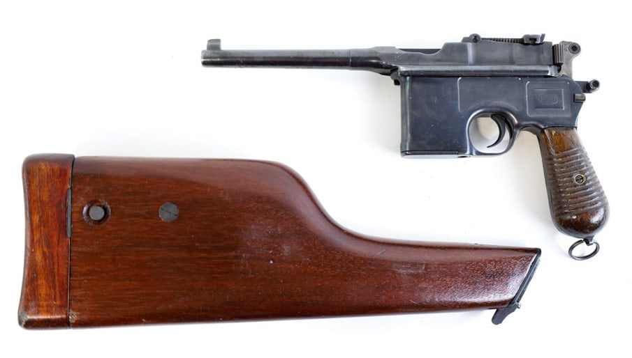 Mauser C96 7.63 x 25mm Mauser Semi-Auto Pistol: German Mauser C96 "Broomhandle" semi-automatic pistol in 7.63 x 25mm Mauser. The blued pistol has a 5.5" barrel and is in good condition with use wear. Comes with the walnut buttstock case. FFL transf