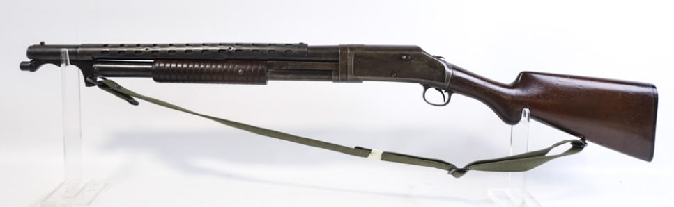 Winchester Model 1897 12 Gauge Trench Shotgun: Winchester Model 1897 pump action trench shotgun in 12 gauge cyl.choke. The shotgun has a 20-1/8" barrel that apears to be shortened for trench use. The shotgun is in good used condition. Comes heat s