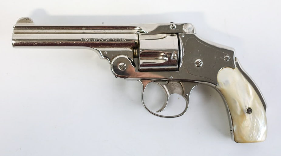 Smith & Wesson Safety Hammerless .38 S&W Revolver: Smith & Wesson Safety Hammerless 5th Model five-shot revolver in .38 S&W. The nickel finish revolver has a 4" barrel and is in nice condition with use and age wear. Comes with mother-of-pearl grips. F