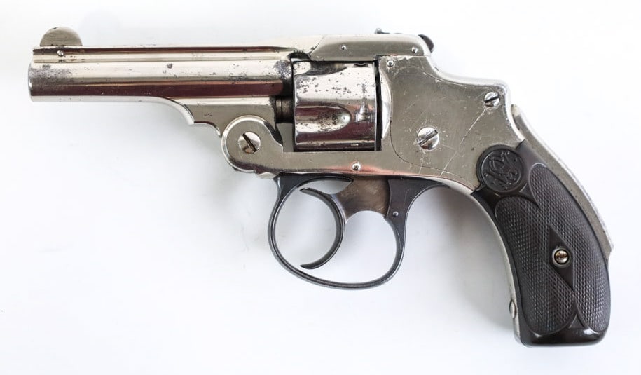 Smith & Wesson Safety Hammerless .32 S&W Revolver: Pre-1899 Smith & Wesson Safety Hammerless top-break five-shot revolver in .32 S&W. The nickel finish revolver has a 3" barrel and is in good condition with use and age wear. SN: 69687.