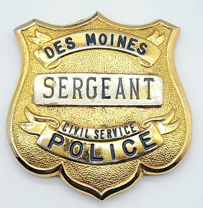 Obsolete Des Moines Iowa Police Sergeant Badge: Obsolete Des Moines Iowa Police Sergeant Badge. Nice badge with stippled background and some wear to the brass finish. Measures 2-1/2in.