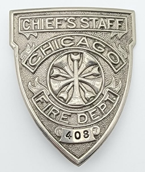 Obsolete Chicago Fire Dept. Chief's Staff Badge: Obsolete Chicago Fire Dept. Chief's Staff Badge #408. Badge is in nice condition and displays well with siren graphic and has pin back and is unmarked. Measures 2-1/4in.