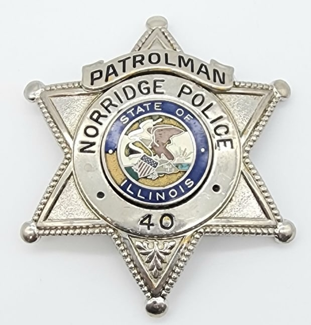 Obsolete Norridge Illinois Police Patrolman Badge: Obsolete Norridge Illinois Police Patrolman Badge. Badge is in nice condition with some finish wear and a chip out of the enamel, ball point tips, pin back, and is marked Blackinton. Measures 3in.