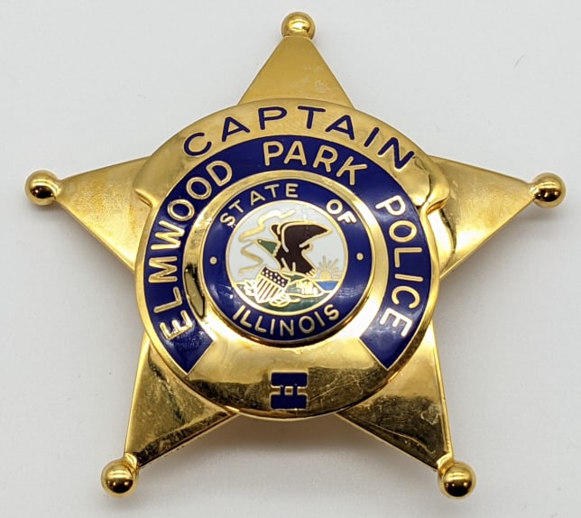 Obsolete Elmwood Park Ill. Police Captain Badge: Obsolete Elmwood Park Illinois Police Captain Badge. Badge is in nice condition with ball point tips, pin back, and is marked V.H..B.. Measures 2-7/8in.