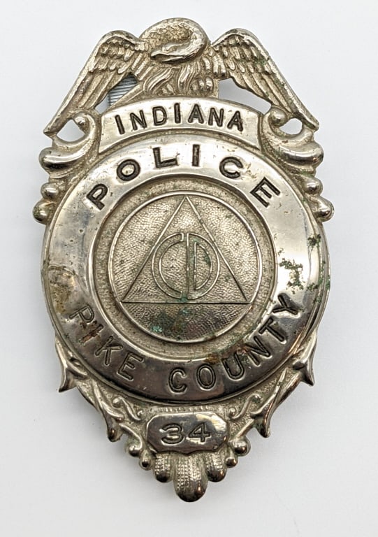 Obsolete Pike County Indiana Police Badge #34: Obsolete Pike County Indiana Police Badge #34. Badge is in nice condition with some finish loss, eagle topper, pin back, and is unmarked. Measures 2-7/8in.
