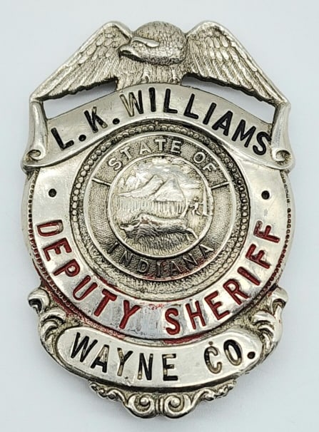Obsolete Named Wayne County Deputy Sheriff Badge: Obsolete Named Wayne County Deputy Sheriff Badge. Badge is in nice condition with some wear from age, pin back, and is named L.K. Williams and hand marked on the back RET RED 1968. Measures 2-1/2in.