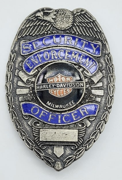 Harley-Davidson Security Enforcement Officer Badge: Harley-Davidson Security Enforcement Officer Badge. Badge is in nice condition with wear from use, pin back, and is unmarked. Measures 3-1/8in.