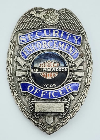 Harley-Davidson Security Enforcement Officer Badge: Harley-Davidson Security Enforcement Officer Badge. Badge is in nice condition with wear from use, pin back, and is unmarked. Measures 3-1/8in.