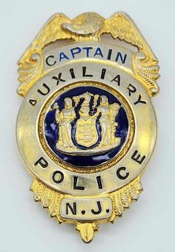 Obsolete New Jersey Auxillary Police Captain Badge: Obsolete New Jersey Auxillary Police Captain Badge. Badge is in nice condition with wear from use and age, pin back, and is unmarked. Measures 2-5/8in.
