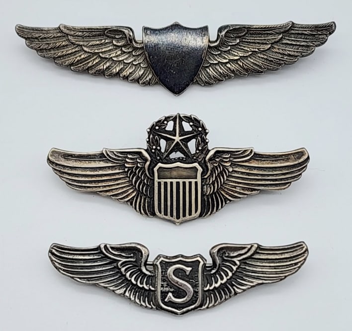 WW2 USAF Sterling Silver Pilots Wings: WW2 USAF Sterling Silver Army Airforce, Service Pilot, & Commander Wings. Badges are in nice condition with light wear from age. Largest measures 2-1/2in.