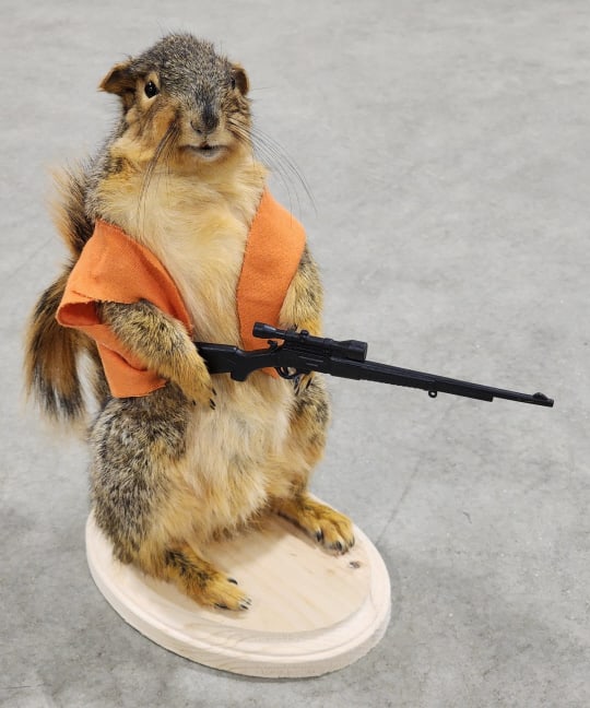 Rifle Packin' Hunting Squirrel with Vest: Rifle Packin' Hunting Squirrel with Vest. Piece is in new condition and displays nicely on wooden base. Overall measures approx 5in wide x 11in tall x 8in deep.