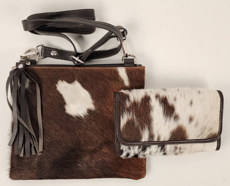 Brand New Cowhide Cross Body Purse w/ Wallet: Brand New Cowhide Cross Body Purse w/ Wallet. Piece is in nice new condition with brown and white coloration. Purse measures approx 10in x 8-1/2in..