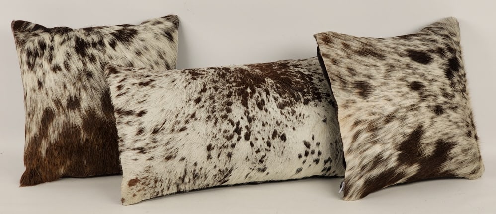 Set of 3 New Brown & White Cowhide Pillows: Set of 3 New Brown & White Cowhide Pillows. Pieces are in nice new condition and display nicely. Measures approx 14in x 14in and 24in x 12in.