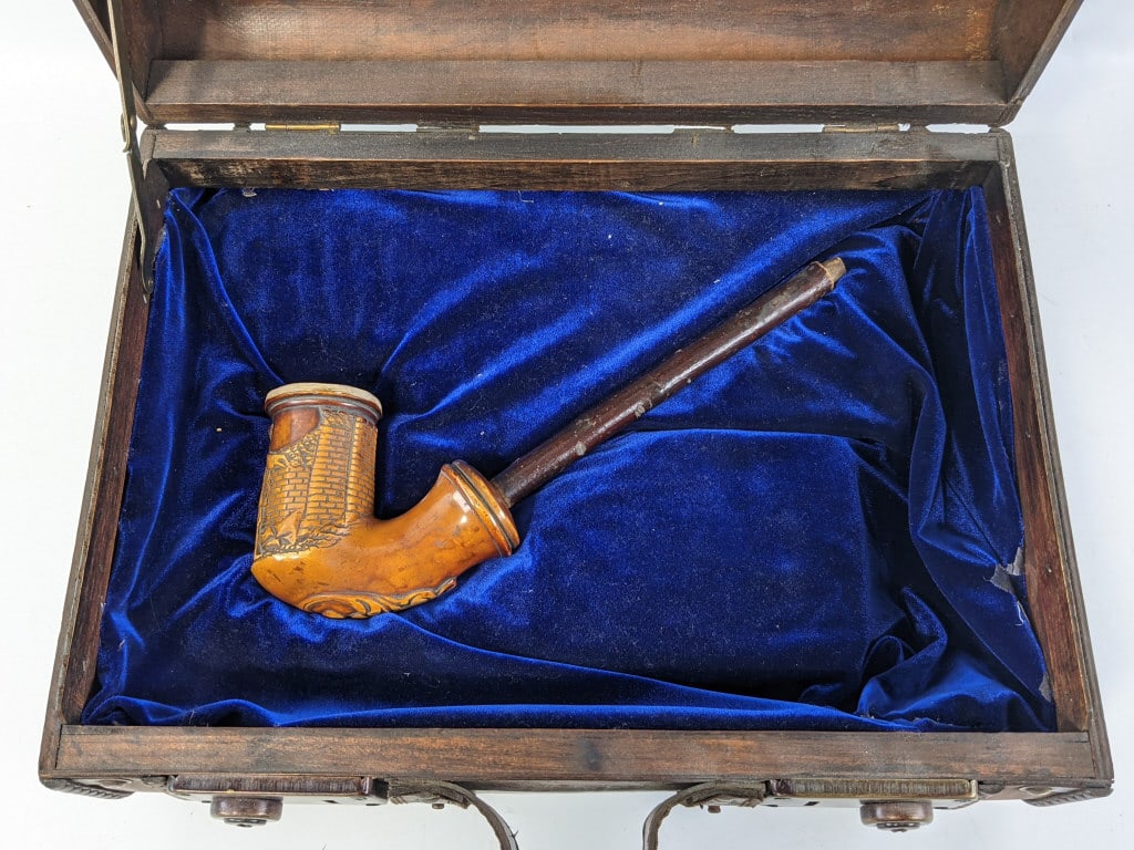 1800's Carved Meerschaum Pipe w/ Case: 1800's Carved Meerschaum Pipe w/ Case. Pipe features carved design of a soldier leaning against a brick wall and some scrollwork. Pipe is in nice used condition with some charring on the inside and co