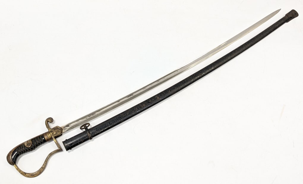 WW2 Era German Army Officers Sword & Scabbard: WW2 Era German Army Officers Sword & Scabbard by Eickhorn Solingen. This saber is an 1889 Pattern dove?s head pattern sword and features a black composite grip with a wire wrap and brass engraved back