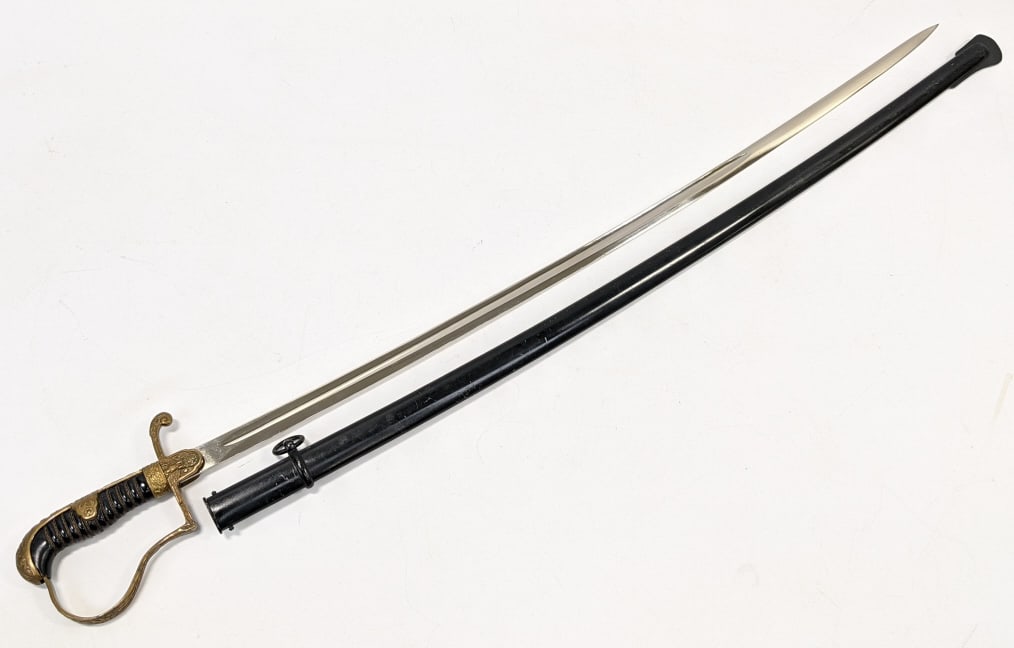 WW2 Era German Army Officers Sword & Scabbard: WW2 Era German Army Officers Sword & Scabbard by F.W. Holler Solingen. This saber is an 1889 Pattern dove?s head pattern sword and features a black composite grip with a wire wrap and brass engraved b
