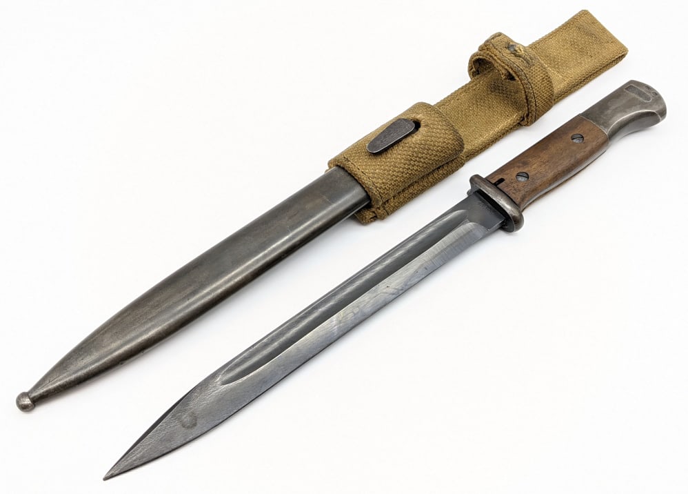 WW2 German K98 Mauser Bayonet w/ Scabbard: WW2 German K98 Mauser Bayonet w/ Scabbard and Frog. Bayonet was made by E.u.F H?rster and has matching serial numbers 6818 as the bayonet. Bayonet features black steel blade with minimal wear, wooden 
