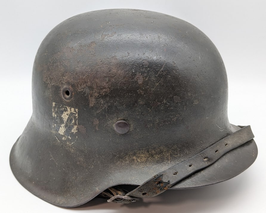 WW2 German SS M42 Military Helmet: WW2 German SS M42 Military Helmet. Helmet is in nice condition with original paint and worn SS decal. Comes with the original leather liner and chin strap and is marked EFR and 1782 on the inside edge