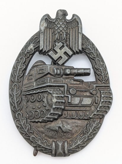 WW2 German Panzer Badge: WW2 German Panzer Badge. The panzer badge was awarded to troops who served in an armored unit. Medal is in nice condition with some light finsh wear from age and use, and the back clasp hook is broken