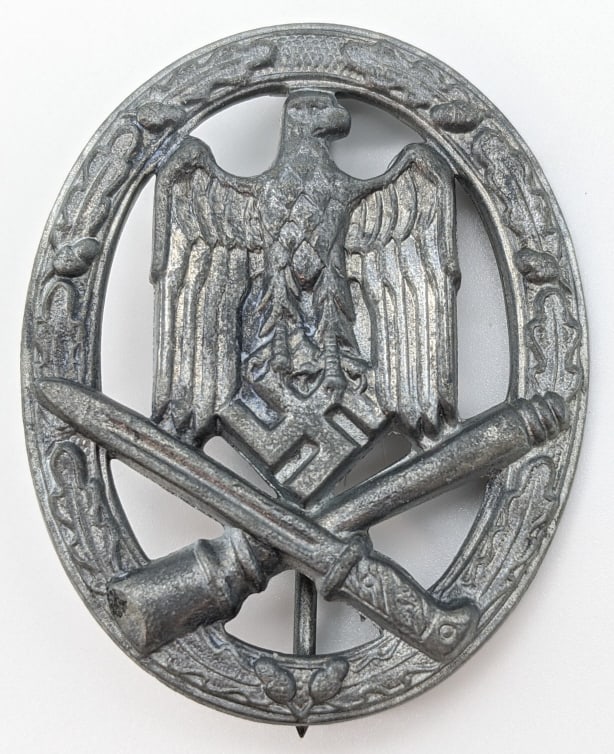 WW2 German General Assault Badge: WW2 German Panzer Badge. The badge was awarded to personel who supported an attack but were not part of a specific infantry unit. Medal is in nice condition with some light finsh wear from age and use