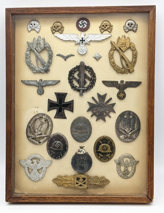 WW2 German Medal Display: WW2 German Medal Display. Display includes a sportsmans badge, infantry and general assault badges, close combat clasp, veterans and general eagle visor cap badges, panzer skull collar tabs, wound bad