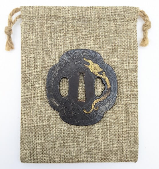 WW2 Japanese Decorated Tsuba Sword Guard: WW2 Japanese Decorated Tsuba Sword Guard. Guard features dragon engraving with gold inlay and geometric and scroll etching. Guard is in very nice condition with some light pitting and wear from use an
