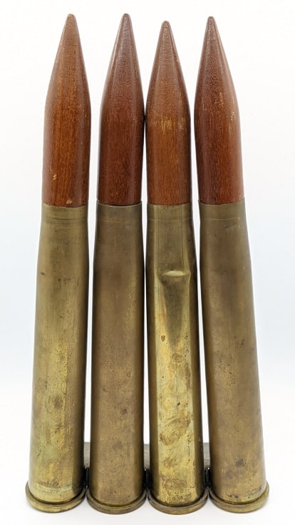 Clip of 40mm Artillery Shells w/ Wooden Bullets: Clip of 40mm Artillery Shells w/ Wooden Projectiles. Shells display well in the metal round holder, and is made for the Bofors L70 Anti Aircraft Gun. Measures 18-1/2in tall.