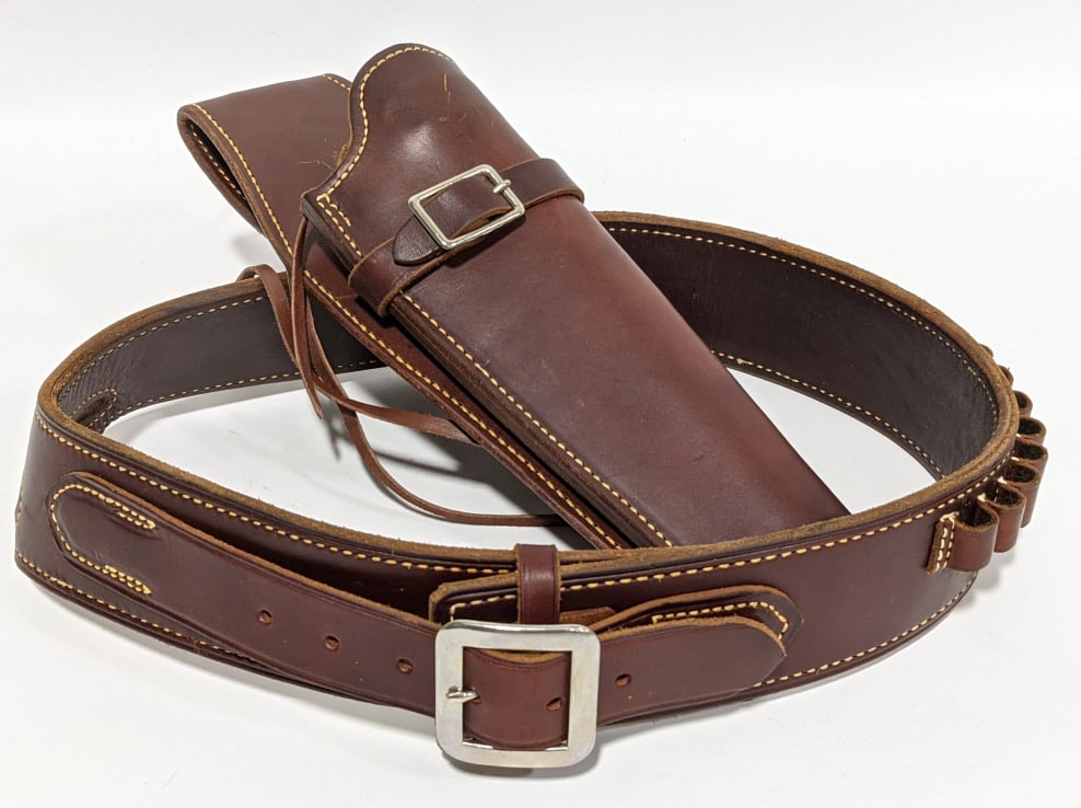 George Lawrence Fine Leather Gun Belt and Holster: George Lawrence Fine Leather Gun Belt and Holster. The belt is marked 79 M 44 and the holster is marked 79 535 meaning it may be for a S&W N .44 Mag 8 3/8 in. Both pieces have a small amount of wear f