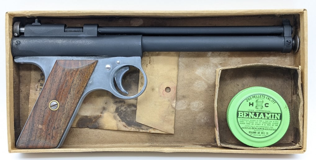Benjamin Model 177 BB Air Pistol w/ Box & BB Tin: Benjamin Model 177 BB Air Pistol w/ Box & BB Tin. Pistol features black finish barrel and action and wooden grips. The barrel has been refinished at some point. Measueres 10-1/4in long.