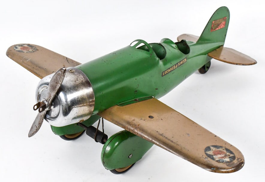 Original Steelcraft Lockhead Sirius AIrplane: Original Steelcraft Lockhead Sirius airplane. This is one of the hardest color variation to find with the green body and tan wings. Nice original example with some paint loss and wear from age. The wi